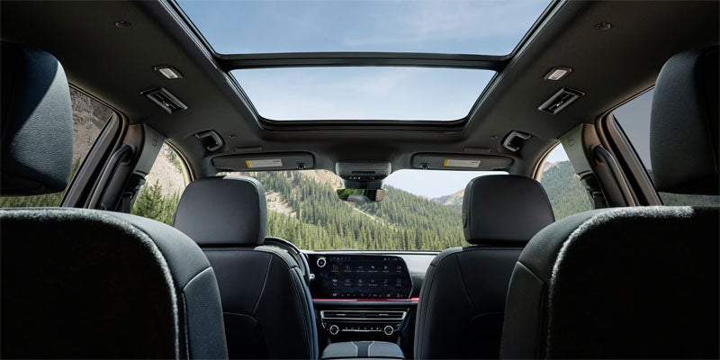 Interior view of a midsize SUV cabin from the second row, looking toward the front seats