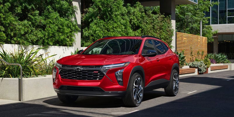 Red compact SUV parked on a city street, viewed from the front three-quarter angle